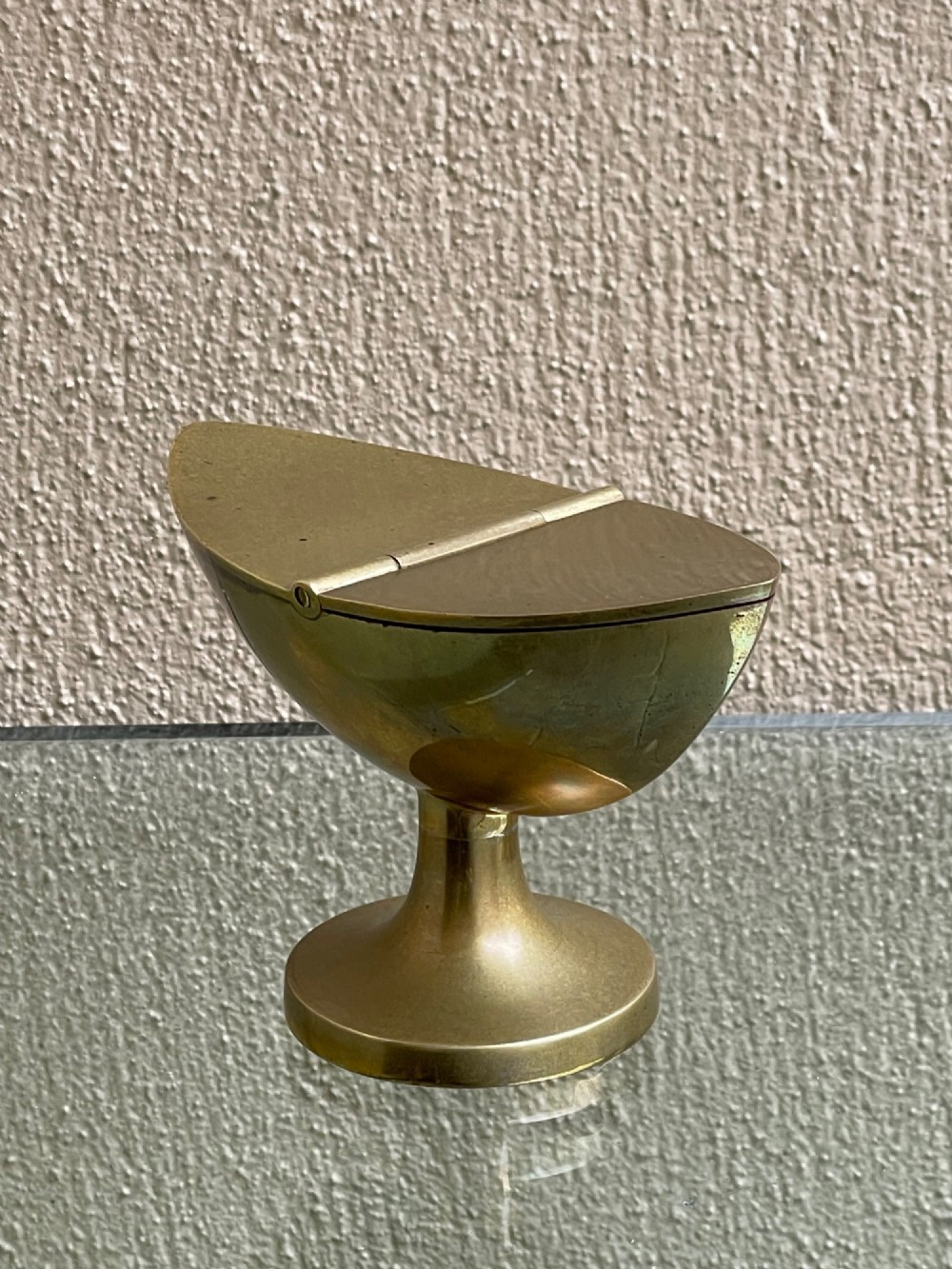 A Georgian navette-shaped brass table snuff box with a central hinged lid elevated on a circular pedestal foot. View III