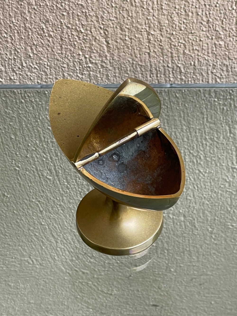 A Georgian navette-shaped brass table snuff box with a central hinged lid elevated on a circular pedestal foot. View IV