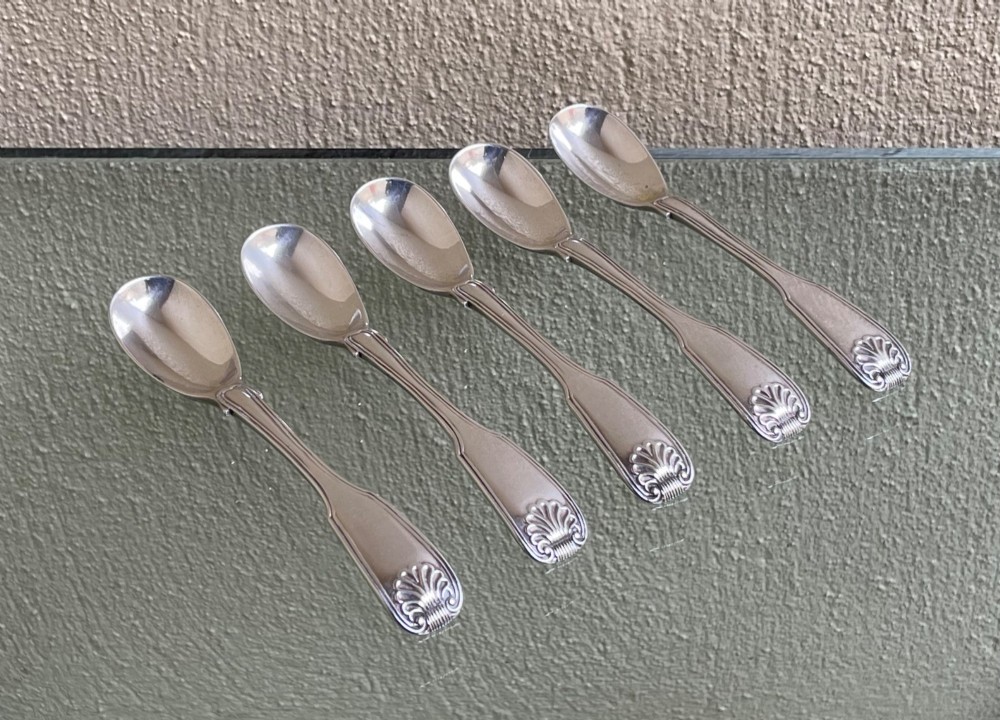 A set of five George IV sterling silver egg spoons featuring fiddle, thread, and shell pattern terminals displayed side by side. View II