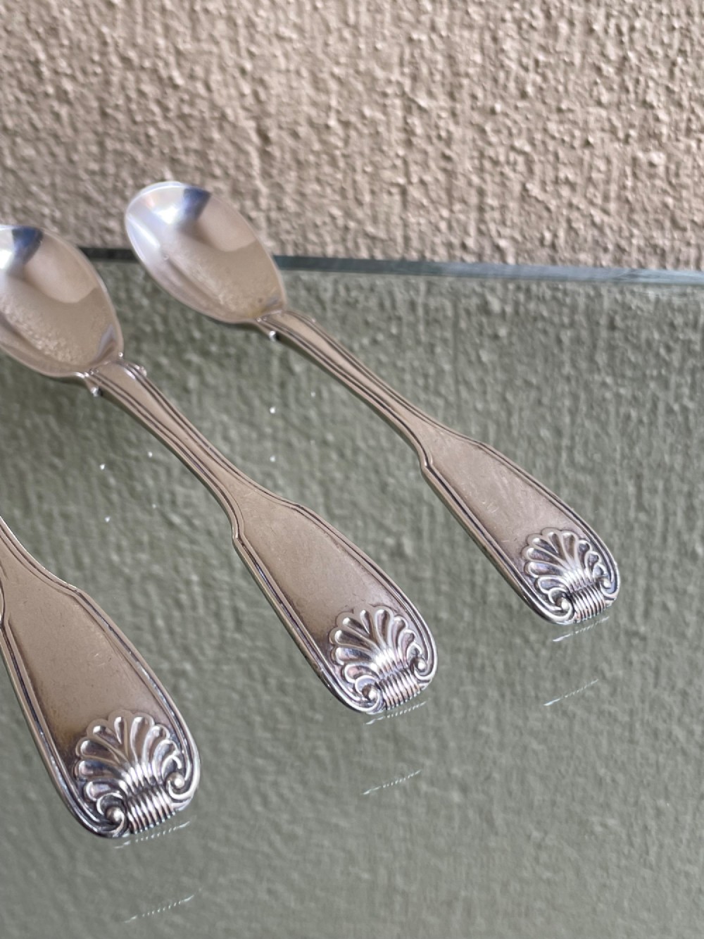 A set of five George IV sterling silver egg spoons featuring fiddle, thread, and shell pattern terminals displayed side by side. View III