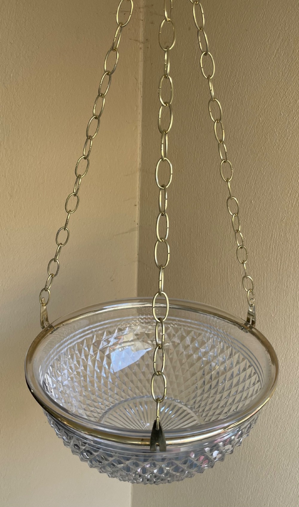 An Edwardian period cut glass bowl light shade suspended by three brass link chains connected to a central brass rim. View IV