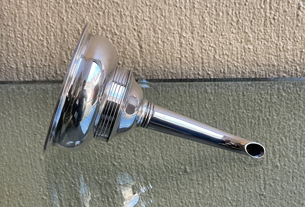 A polished sterling silver wine funnel featuring a wide rimmed bowl and a tapered curved spout resting on a flat surface.