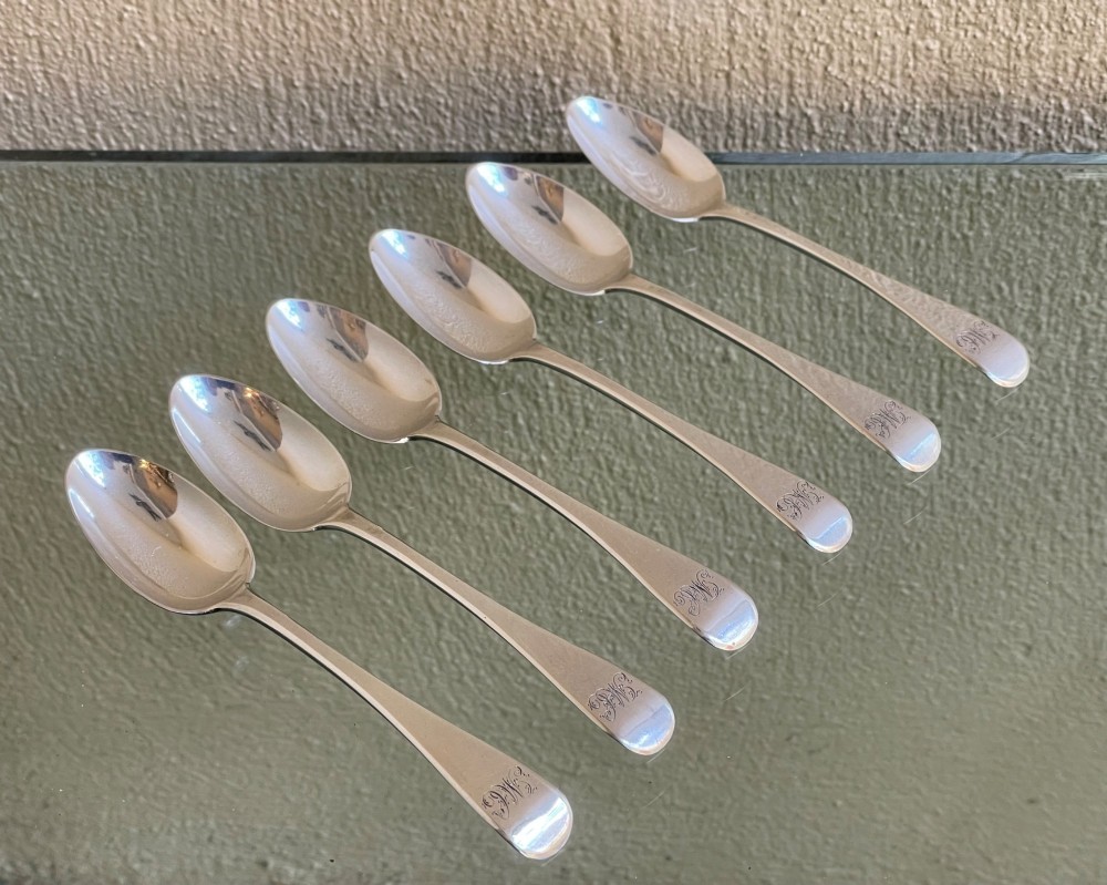 A set of six Victorian silver teaspoons featuring oval bowls and engraved initial monograms on the handles. View II