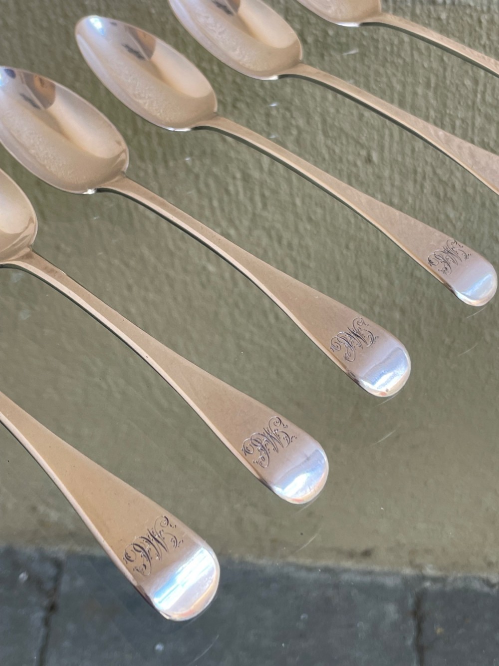 A set of six Victorian silver teaspoons featuring oval bowls and engraved initial monograms on the handles. View III