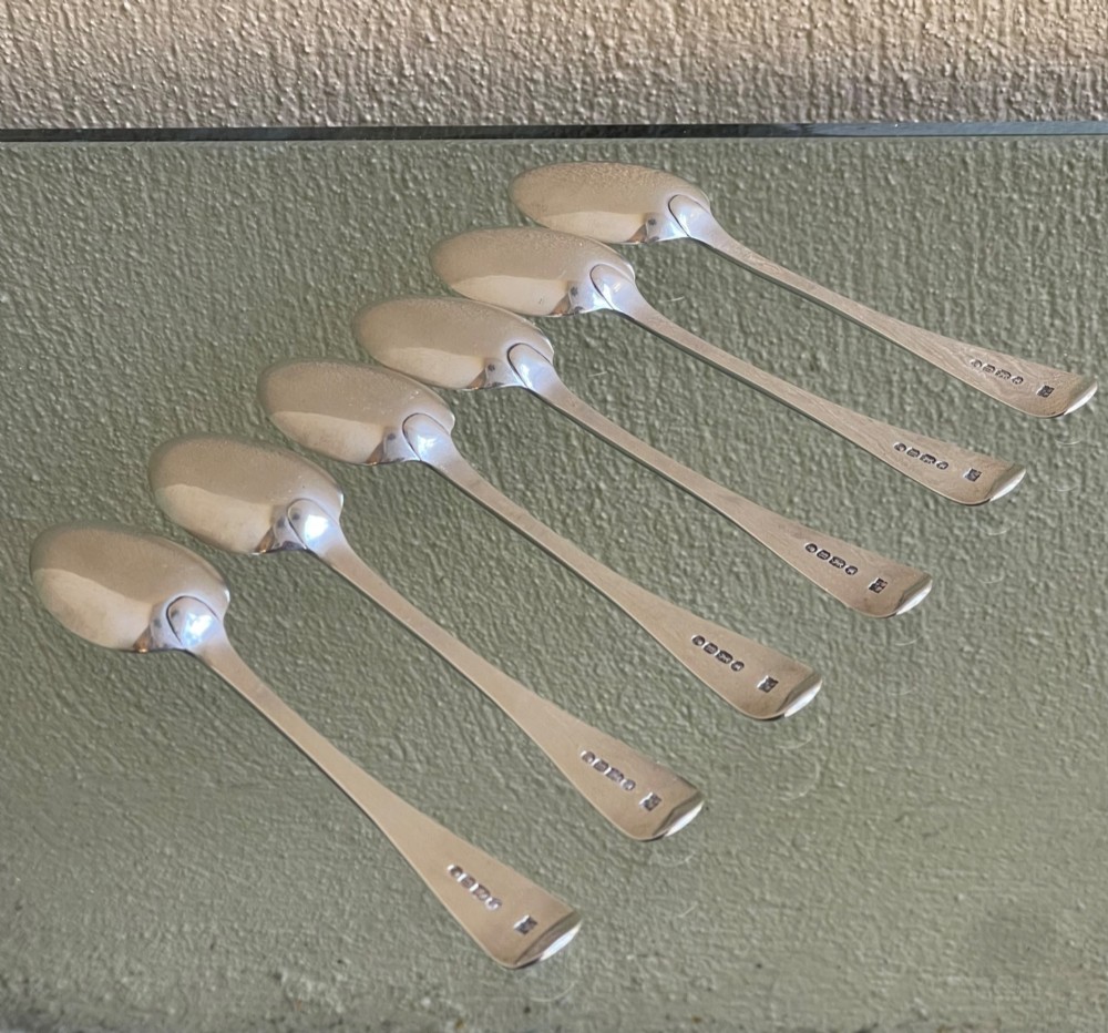 A set of six Victorian silver teaspoons featuring oval bowls and engraved initial monograms on the handles. View IV