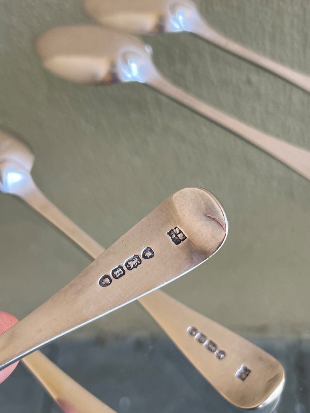 A set of six Victorian silver teaspoons featuring oval bowls and engraved initial monograms on the handles. View V