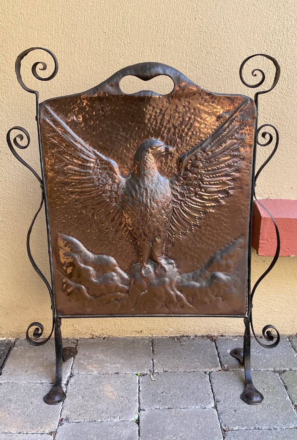 An Arts and Crafts copper fire screen featuring a hammered repousse eagle design framed by wrought iron scrollwork. View II