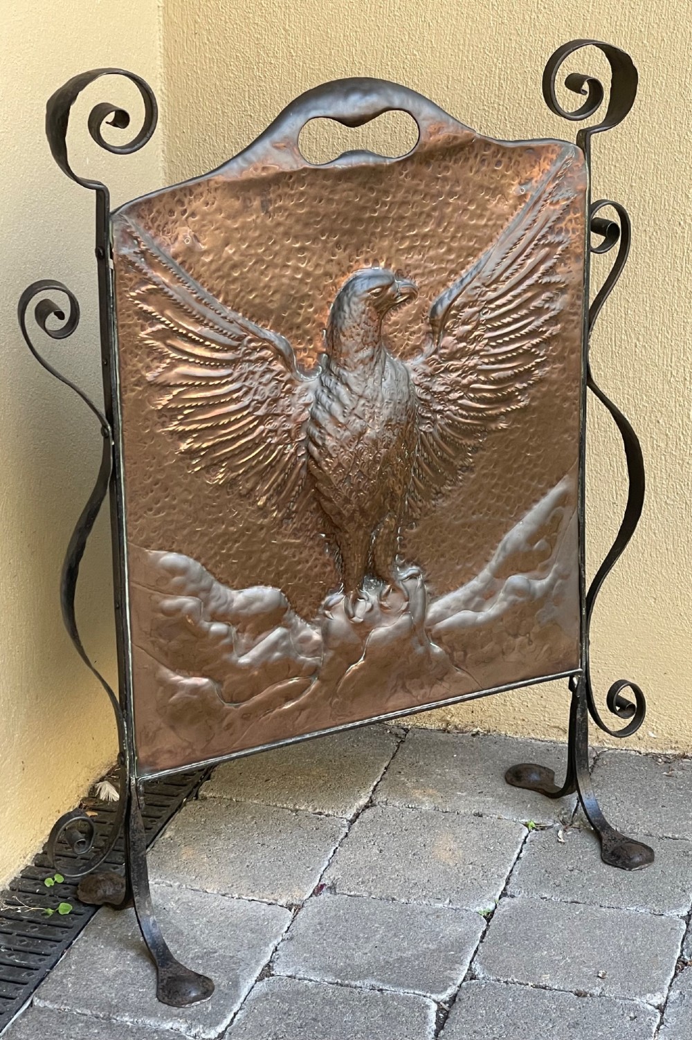 An Arts and Crafts copper fire screen featuring a hammered repousse eagle design framed by wrought iron scrollwork. View III