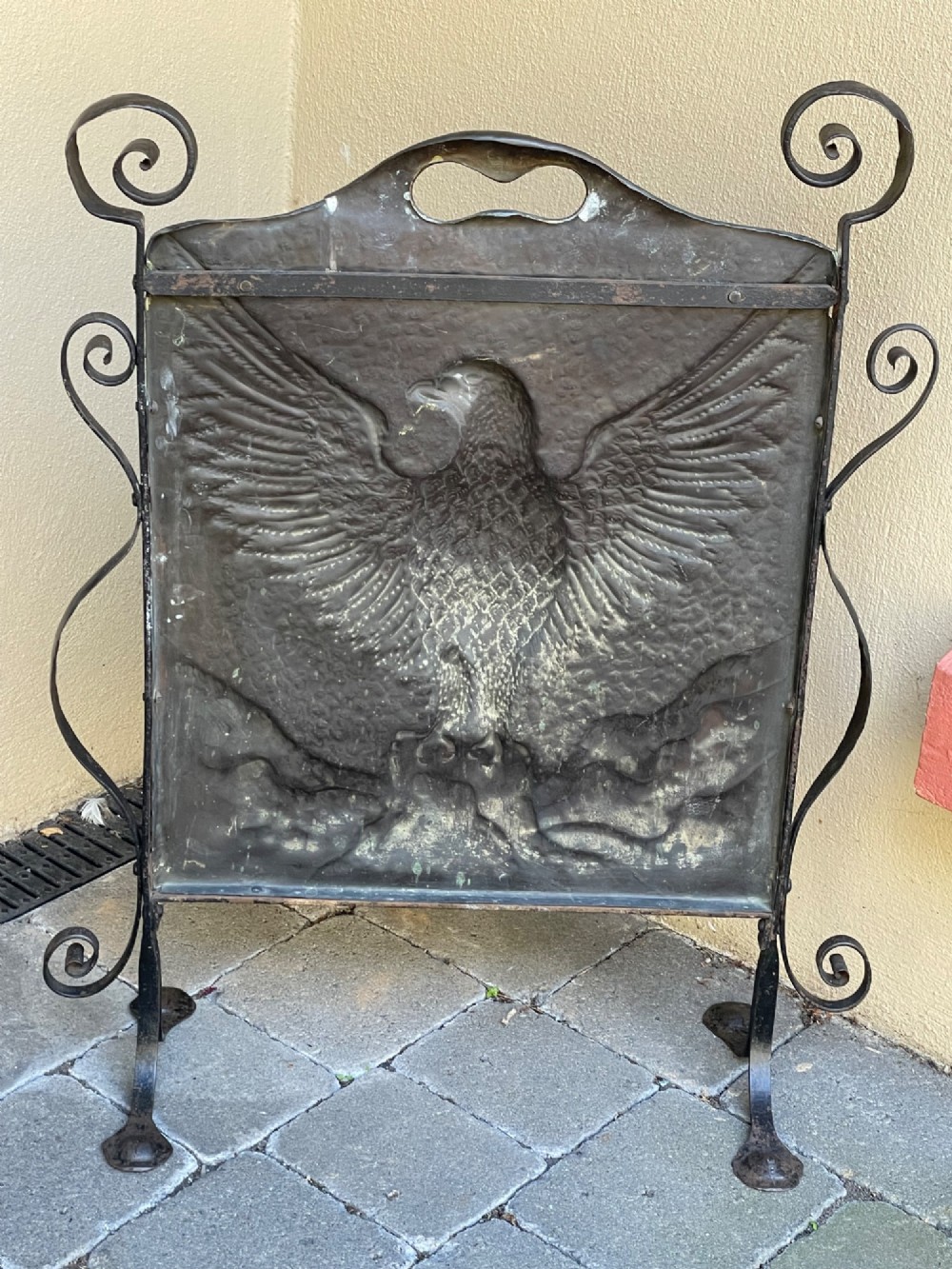 An Arts and Crafts copper fire screen featuring a hammered repousse eagle design framed by wrought iron scrollwork. View IV