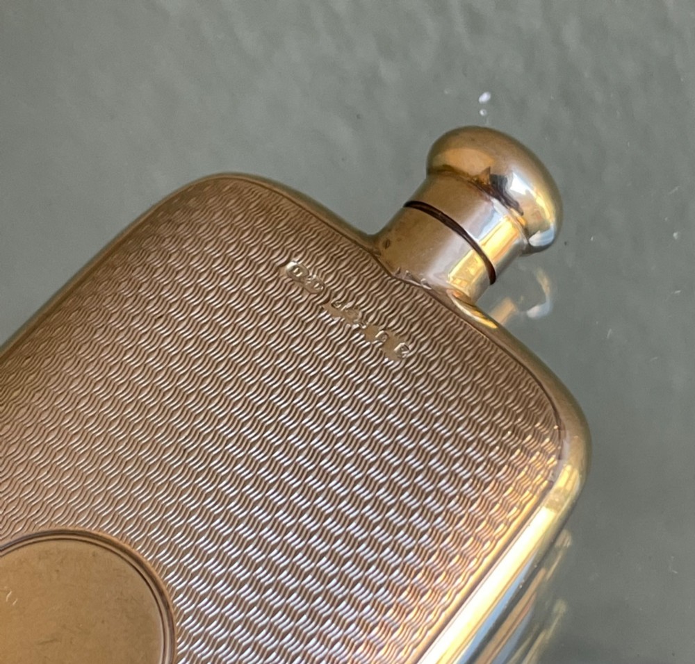 A small rectangular 9ct yellow gold scent flask featuring fine engine-turned geometric detailing, a central circular cartouche, and a screw top. View III