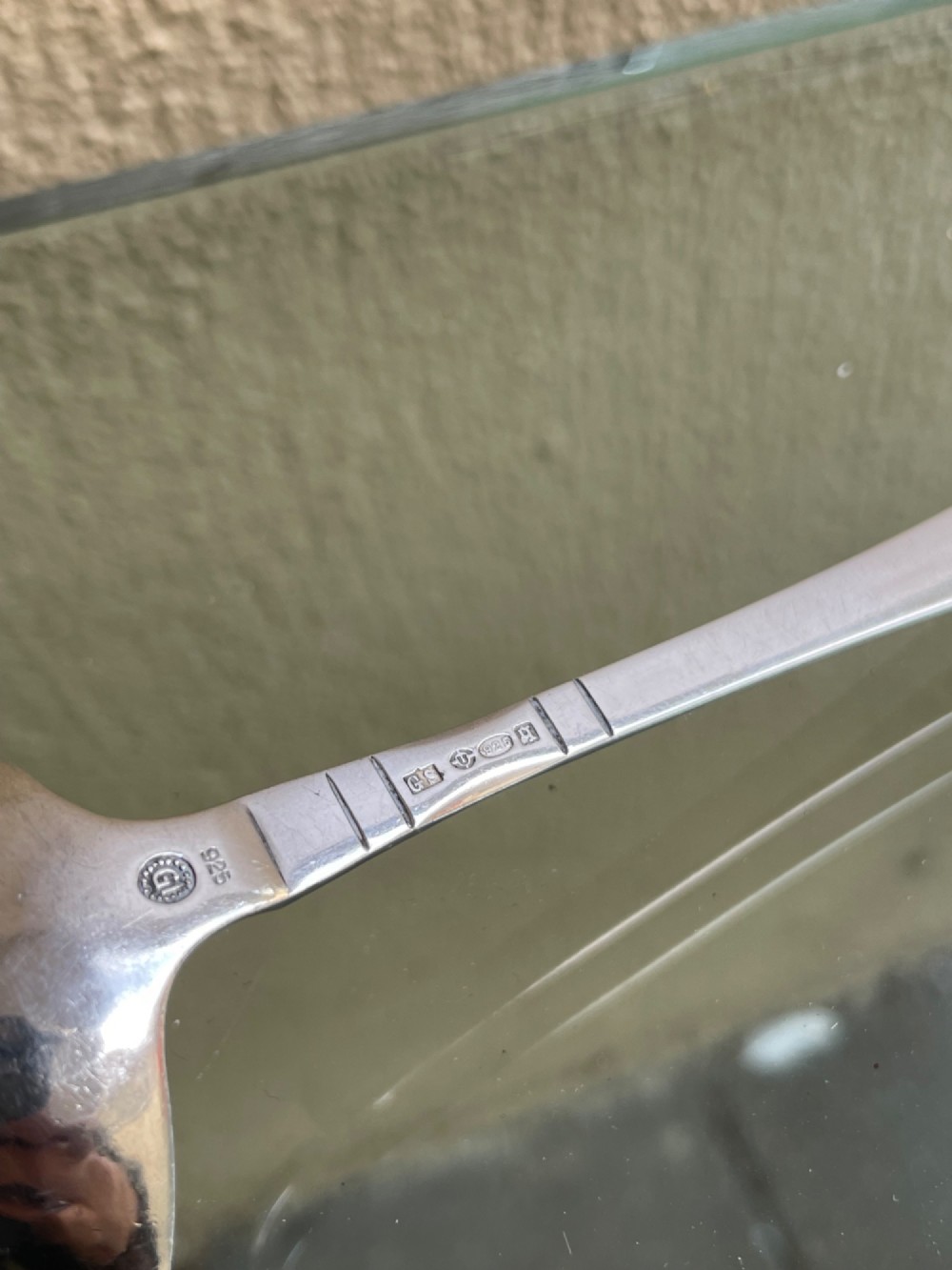 A sterling silver Georg Jensen sauce ladle with a side pouring spout and a slender handle with linear accents. View IV