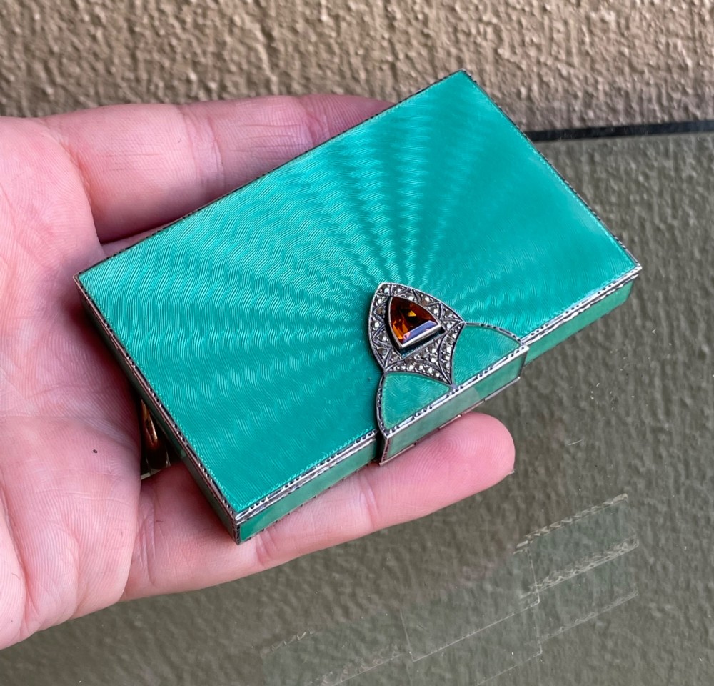 An Art Deco rectangular silver card case featuring turquoise sunburst guilloche enamel and a triangular gemstone clasp. View II