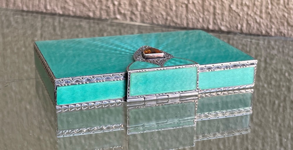 An Art Deco rectangular silver card case featuring turquoise sunburst guilloche enamel and a triangular gemstone clasp. View III
