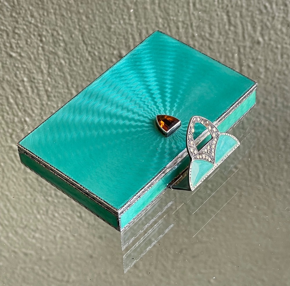An Art Deco rectangular silver card case featuring turquoise sunburst guilloche enamel and a triangular gemstone clasp. View IV
