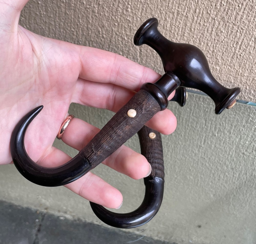 A pair of Victorian boot pulls featuring turned dark handles with bone inlays and curved horn hooks. View IV
