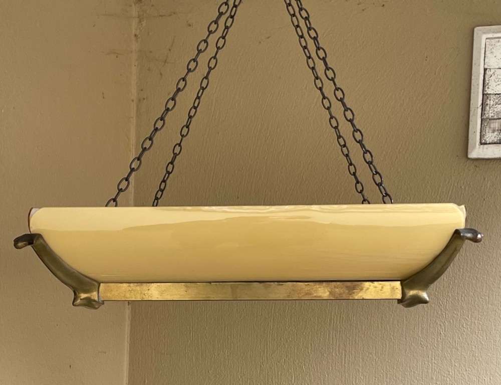 An Art Deco square pendant ceiling light featuring yellow glass side panels set within a brass frame, suspended by dark metal chains. View III
