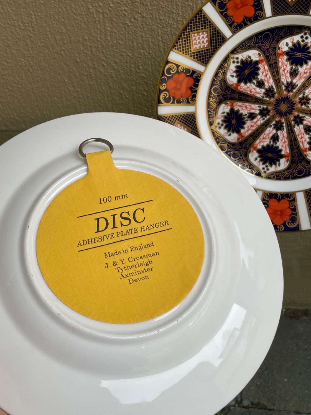 A pair of circular fine bone china plates decorated in an intricate Imari pattern with cobalt blue, iron red floral motifs, and detailed gold gilding. View V