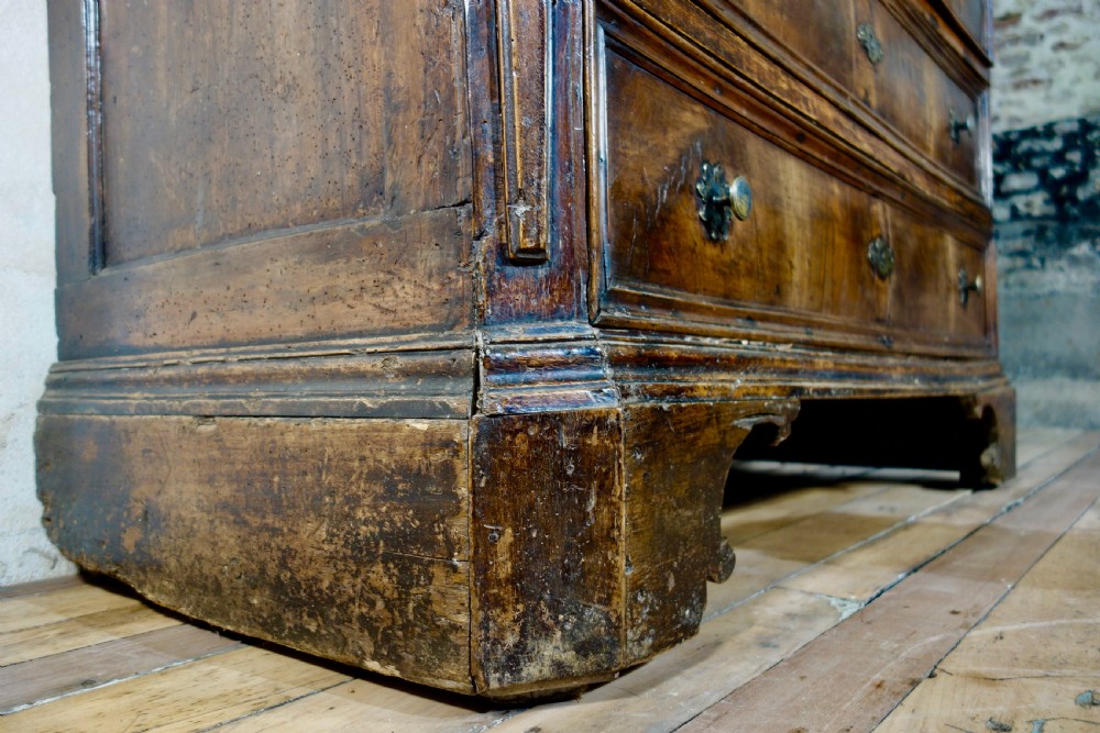 A large seventeenth-century North Italian walnut commode featuring four moulded drawers with brass knobs and key escutcheons. View V