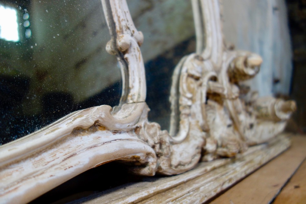 An expansive 19th-century French Rococo wall mirror featuring a carved off-white serpentine frame decorated with ornate acanthus scrolls and cresting. View VIII