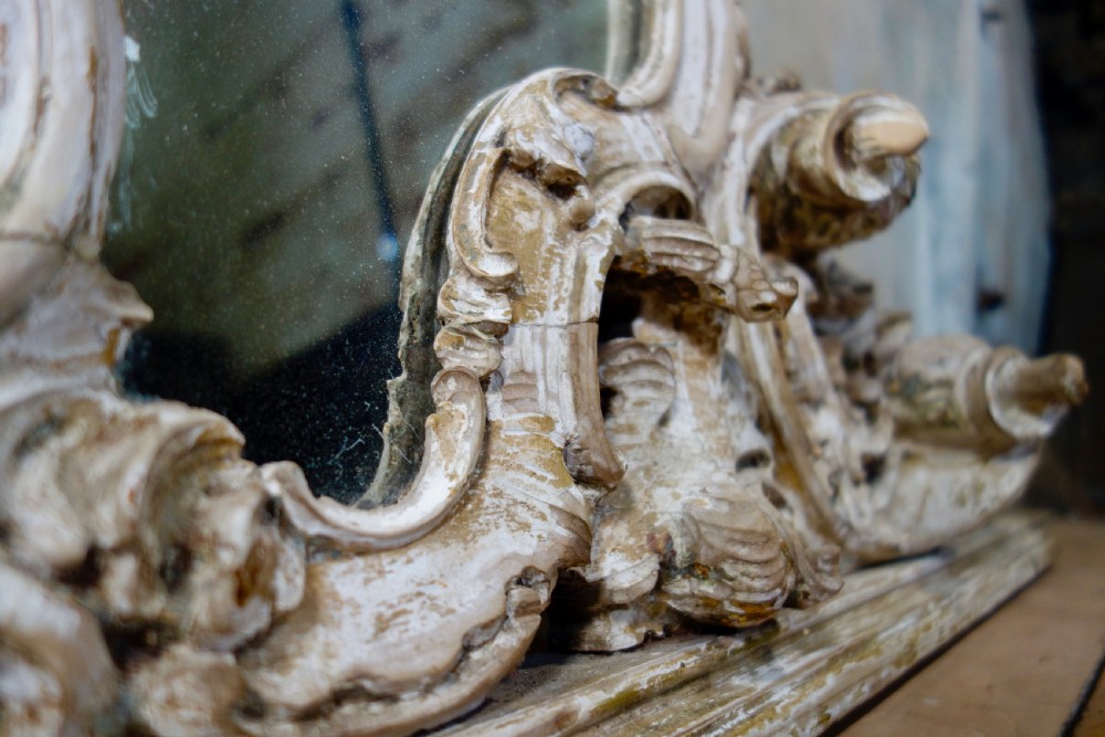 An expansive 19th-century French Rococo wall mirror featuring a carved off-white serpentine frame decorated with ornate acanthus scrolls and cresting. View IX