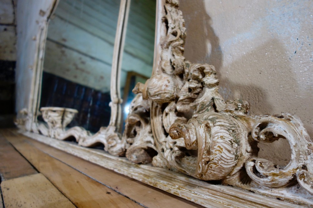 An expansive 19th-century French Rococo wall mirror featuring a carved off-white serpentine frame decorated with ornate acanthus scrolls and cresting. View XI