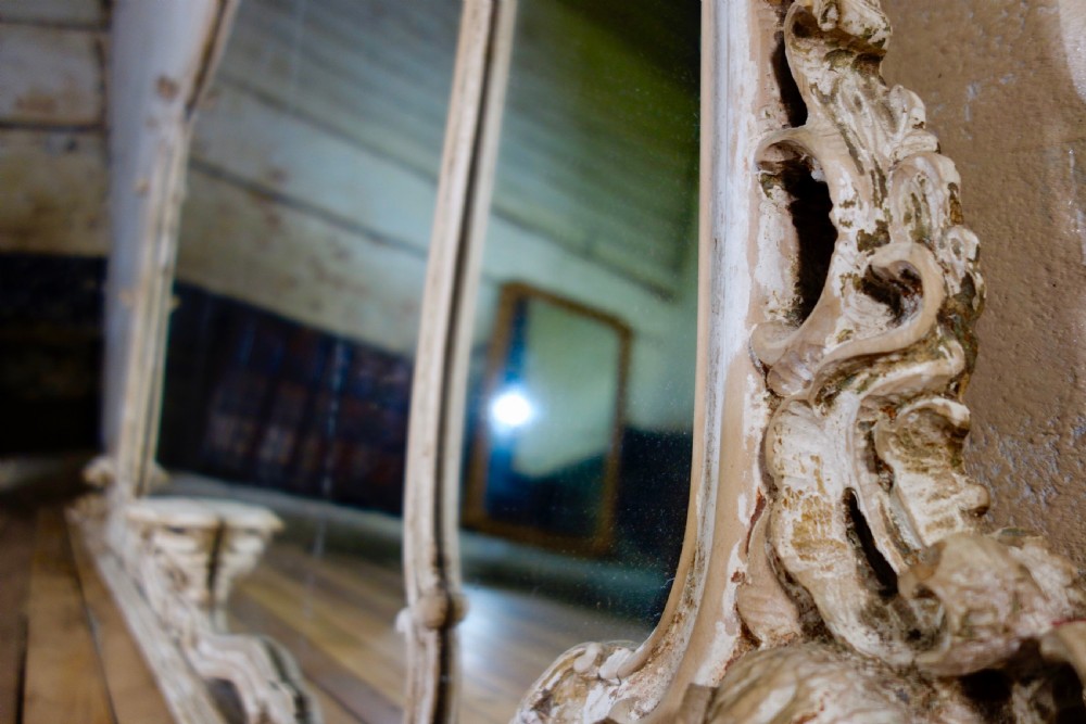 An expansive 19th-century French Rococo wall mirror featuring a carved off-white serpentine frame decorated with ornate acanthus scrolls and cresting. View XIV