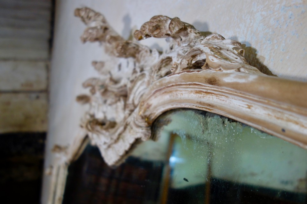 An expansive 19th-century French Rococo wall mirror featuring a carved off-white serpentine frame decorated with ornate acanthus scrolls and cresting. View XVII