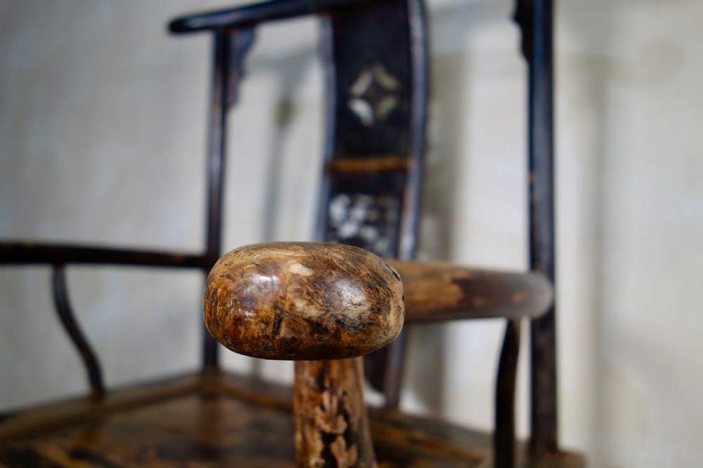 A 19th-century dark elm Chinese officials hat armchair featuring a carved yoke-back crest rail and pierced splat. View III