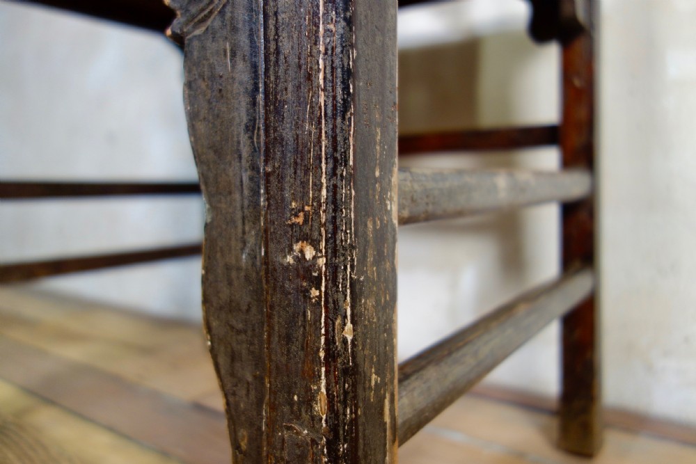 A 19th-century dark elm Chinese officials hat armchair featuring a carved yoke-back crest rail and pierced splat. View VI