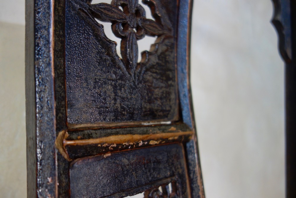 A 19th-century dark elm Chinese officials hat armchair featuring a carved yoke-back crest rail and pierced splat. View XII