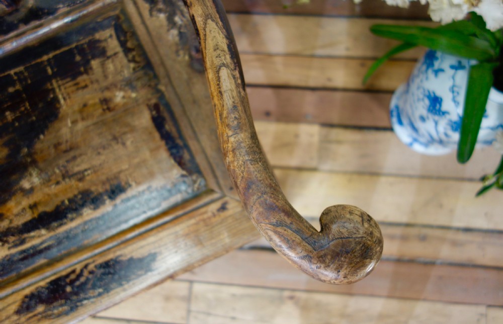 A 19th-century dark elm Chinese officials hat armchair featuring a carved yoke-back crest rail and pierced splat. View XIV