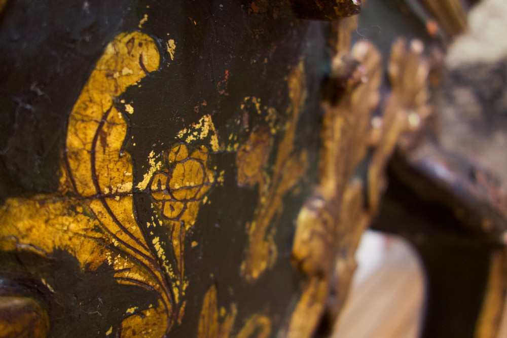 An 18th-century Italian Baroque console table featuring a marble top, a dark painted frame with gilded acanthus leaf carvings, and cabriole legs. View III