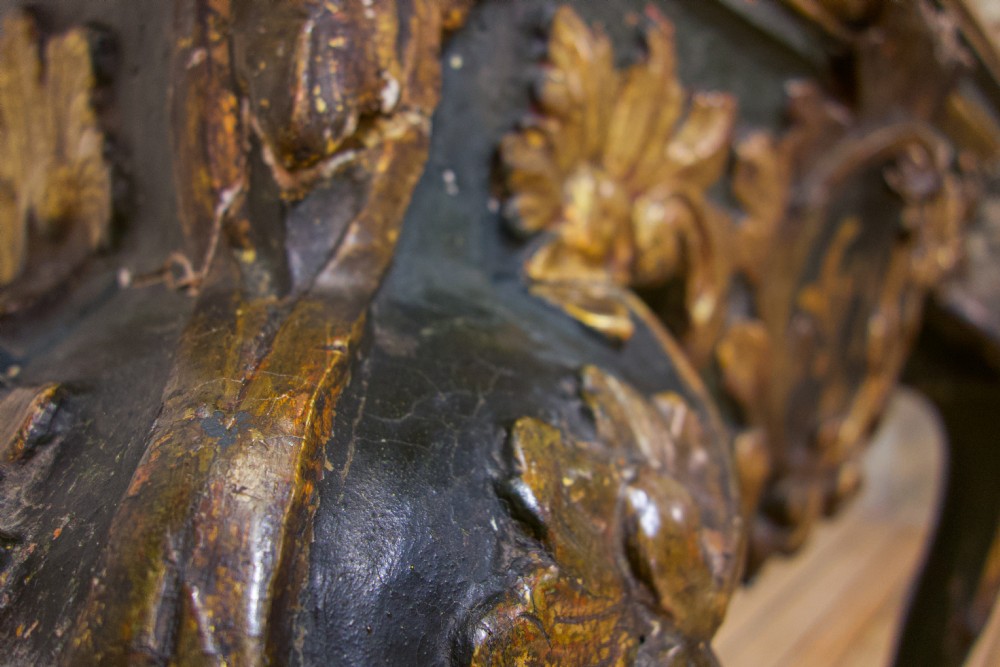 An 18th-century Italian Baroque console table featuring a marble top, a dark painted frame with gilded acanthus leaf carvings, and cabriole legs. View IV