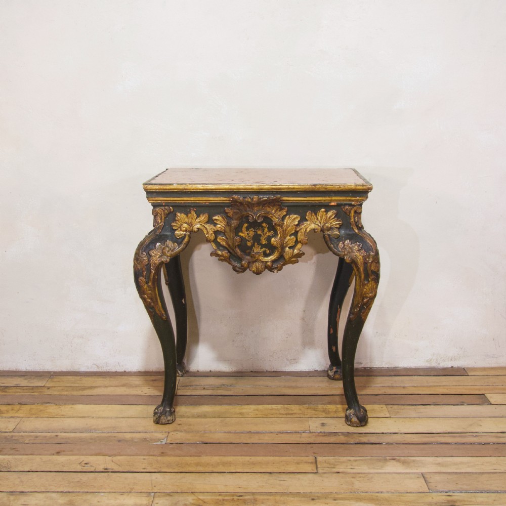 An 18th-century Italian Baroque console table featuring a marble top, a dark painted frame with gilded acanthus leaf carvings, and cabriole legs. View XIII