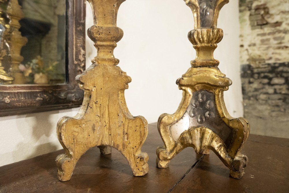 A pair of tall 18th-century Venetian giltwood altar candlesticks featuring carved details, inset mirrored glass panels, and triform bases. View III