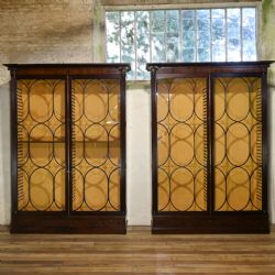 PAIR OF MONUMENTAL REGENCY OVAL ASTRAL GLAZED MAHOGANY LIBRARY BOOKCASES C1810