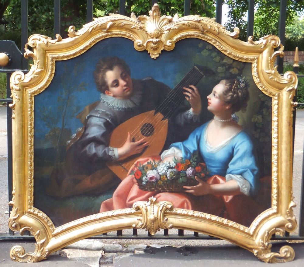 An 18th-century style French Rococo oil painting on canvas depicting a pastoral scene within an elaborate carved gold gilt frame. View II