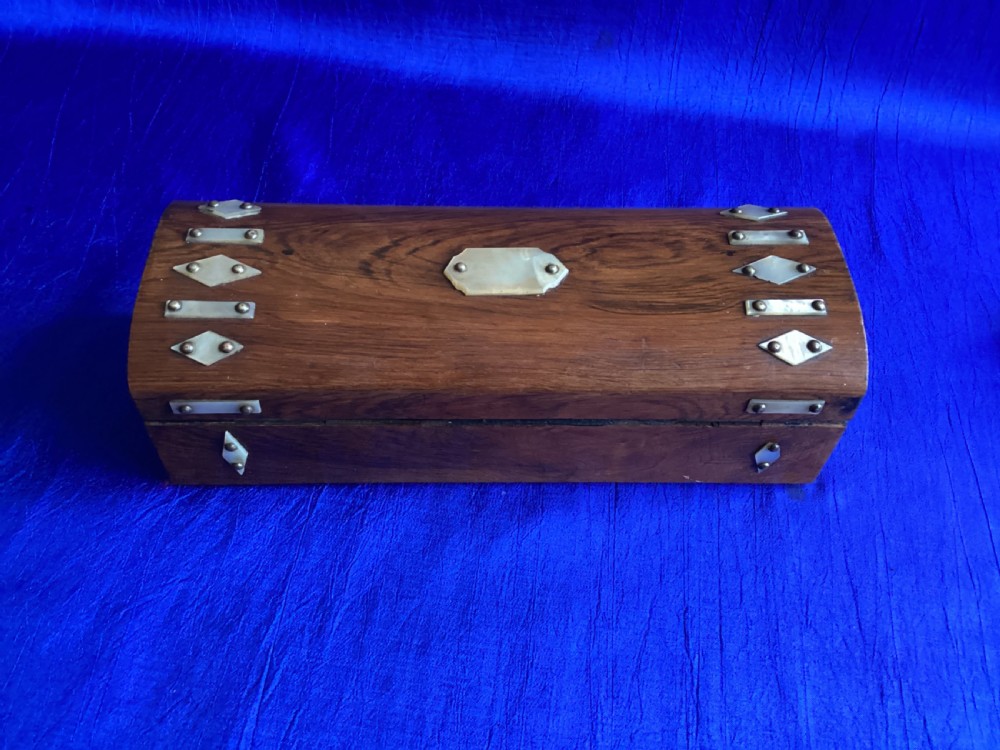 A Victorian rosewood glove box featuring a domed lid, inlaid bone diamond accents, a central escutcheon, and a key with a pink tassel. View VIII