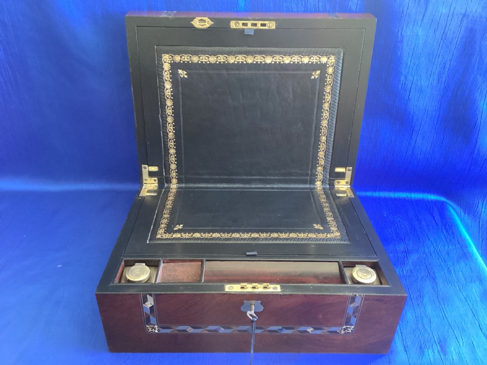A dark rosewood rectangular writing slope featuring mother-of-pearl and abalone shell geometric inlaid borders and a central decorated cartouche. View III
