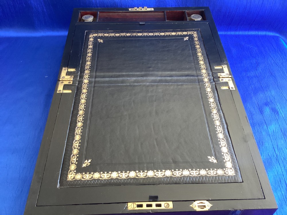 A dark rosewood rectangular writing slope featuring mother-of-pearl and abalone shell geometric inlaid borders and a central decorated cartouche. View V