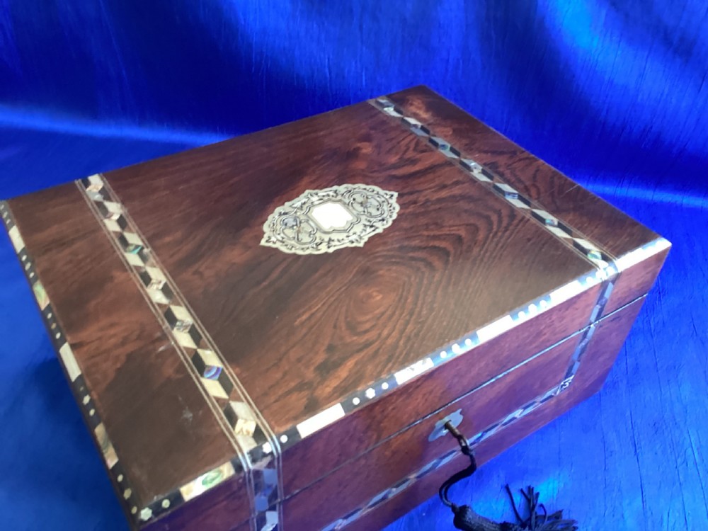 A dark rosewood rectangular writing slope featuring mother-of-pearl and abalone shell geometric inlaid borders and a central decorated cartouche. View IX