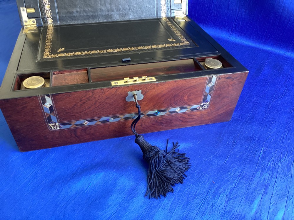 A dark rosewood rectangular writing slope featuring mother-of-pearl and abalone shell geometric inlaid borders and a central decorated cartouche. View X