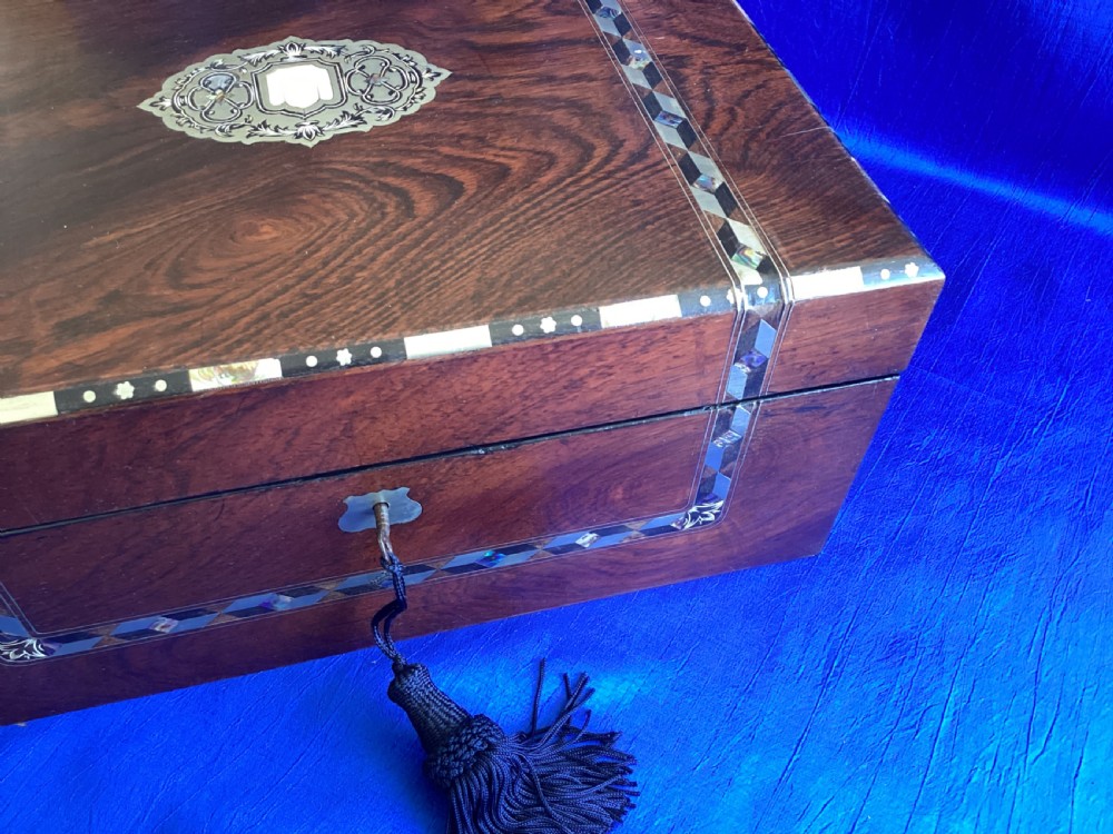 A dark rosewood rectangular writing slope featuring mother-of-pearl and abalone shell geometric inlaid borders and a central decorated cartouche. View XI