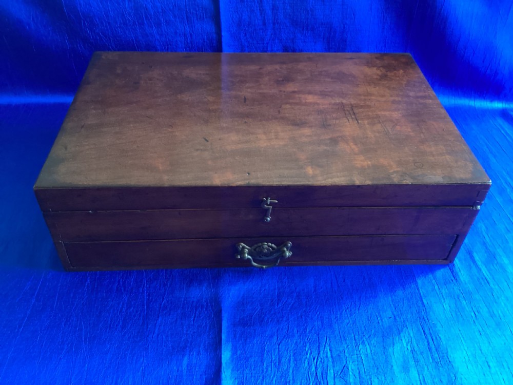 A rectangular Edwardian mahogany artist box featuring a hinged top lid, a lower pull-out drawer with a brass handle, and a brass hook latch on the front.