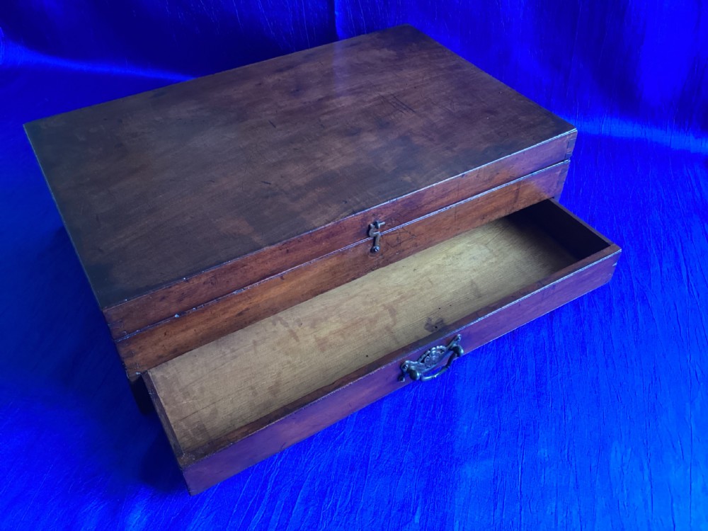 A rectangular Edwardian mahogany artist box featuring a hinged top lid, a lower pull-out drawer with a brass handle, and a brass hook latch on the front. View IV