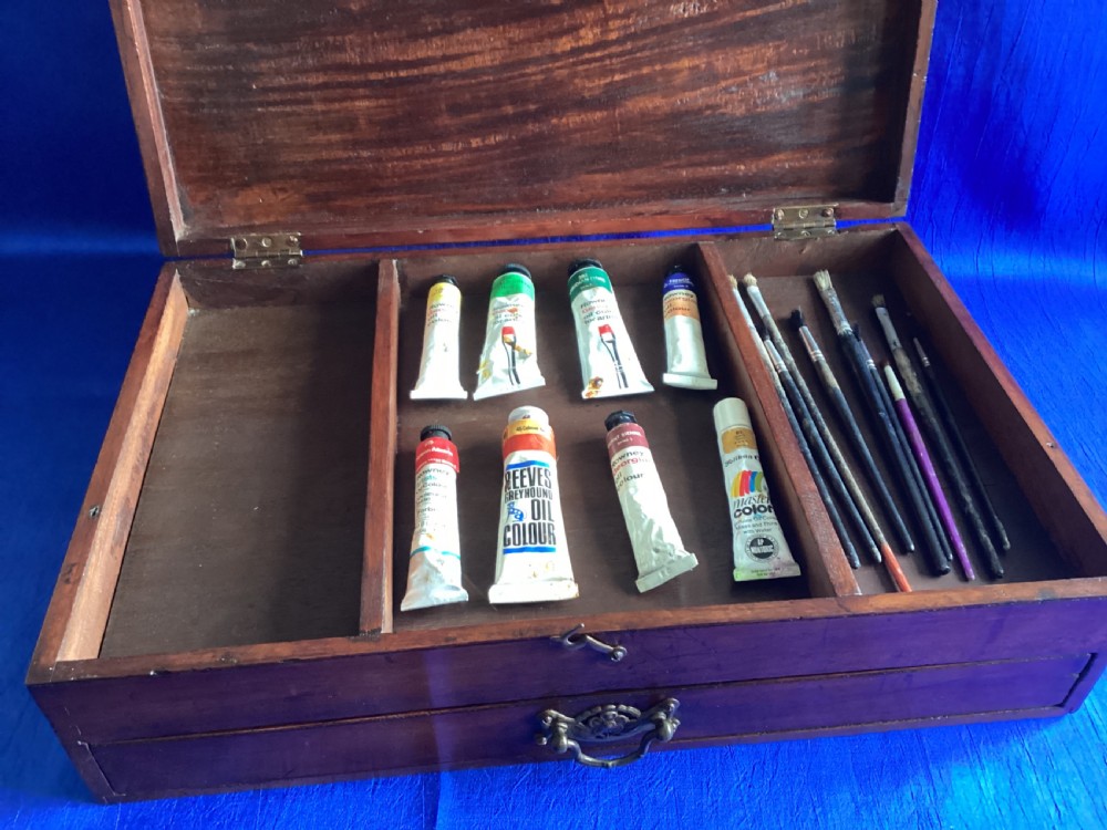 A rectangular Edwardian mahogany artist box featuring a hinged top lid, a lower pull-out drawer with a brass handle, and a brass hook latch on the front. View VI