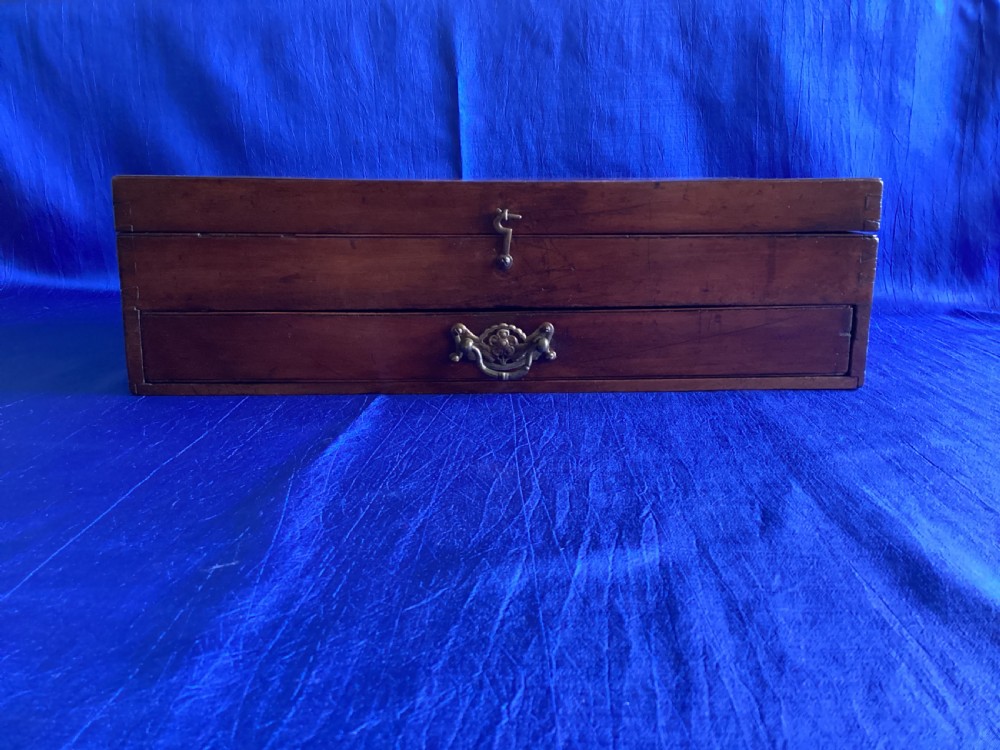 A rectangular Edwardian mahogany artist box featuring a hinged top lid, a lower pull-out drawer with a brass handle, and a brass hook latch on the front. View VII