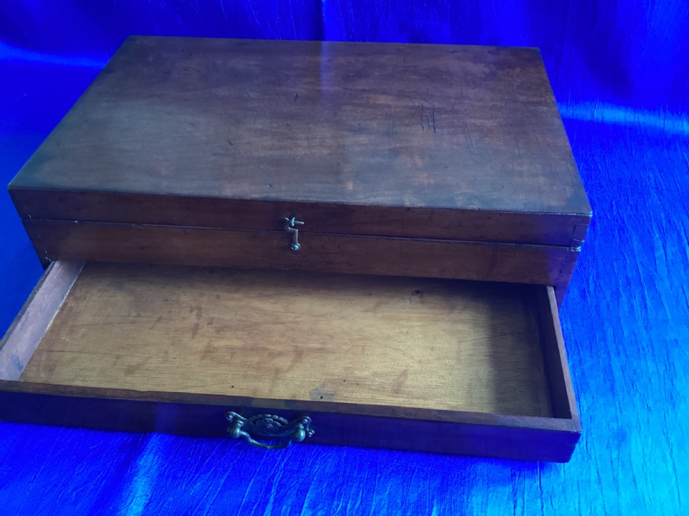 A rectangular Edwardian mahogany artist box featuring a hinged top lid, a lower pull-out drawer with a brass handle, and a brass hook latch on the front. View IX
