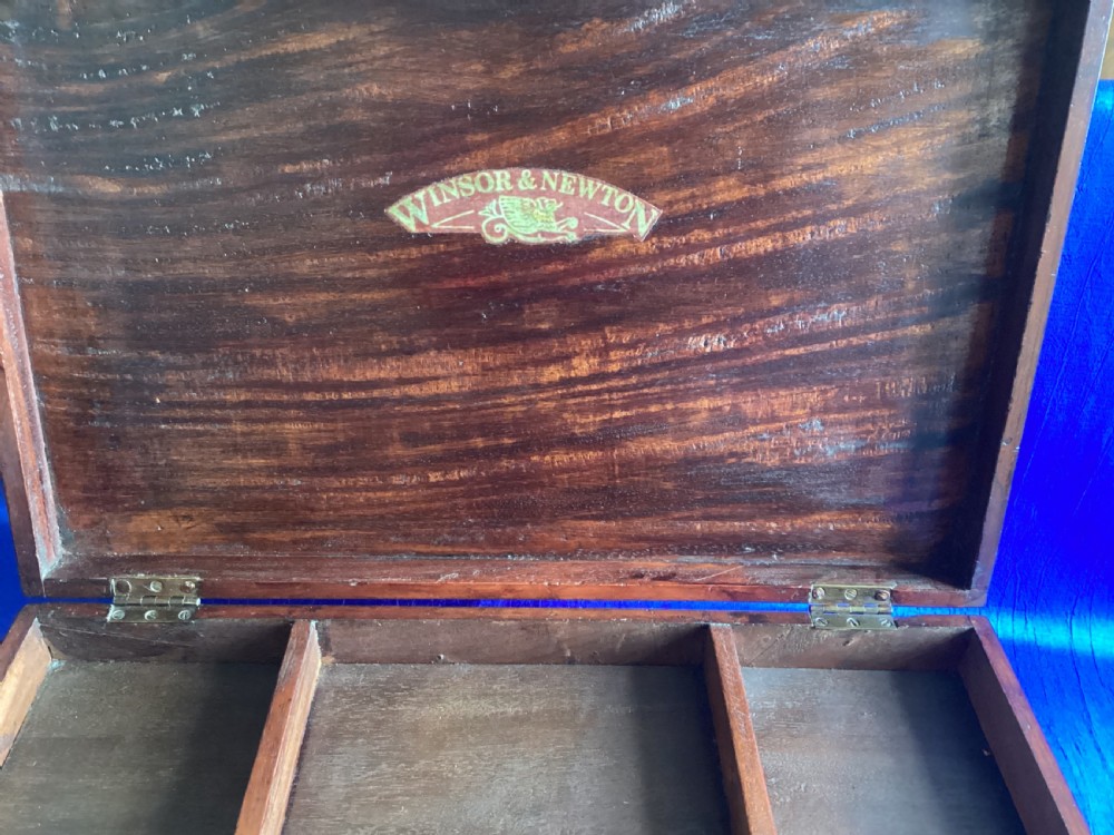 A rectangular Edwardian mahogany artist box featuring a hinged top lid, a lower pull-out drawer with a brass handle, and a brass hook latch on the front. View XI