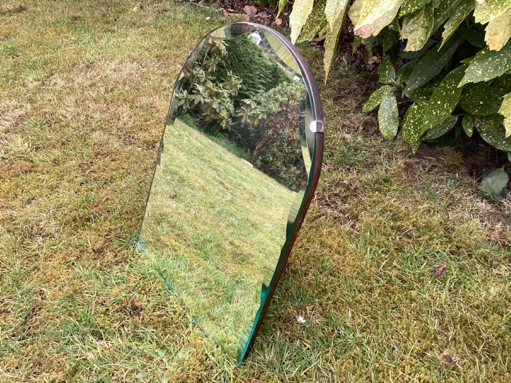 An Art Deco frameless table mirror featuring an arched top, bevelled scalloped edges, and an easel support. View III